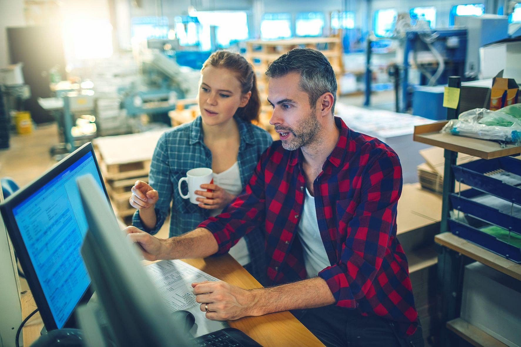 Man and woman looking at computer